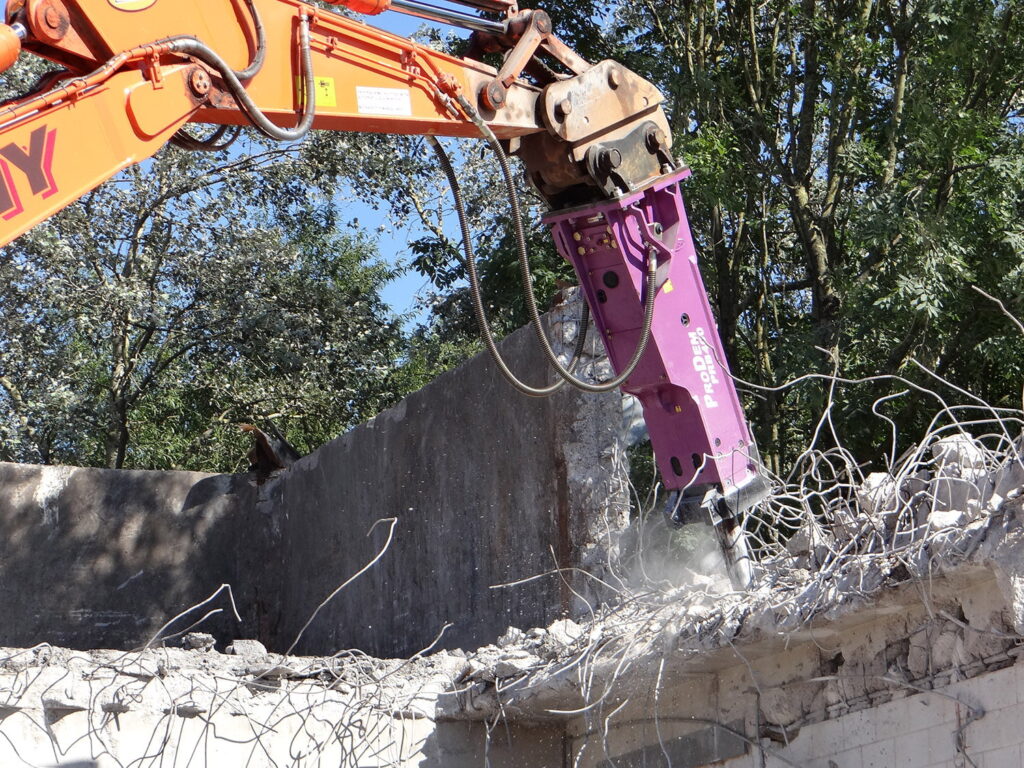 ProDem hydraulic hammer demolishing a reinforced concrete wall