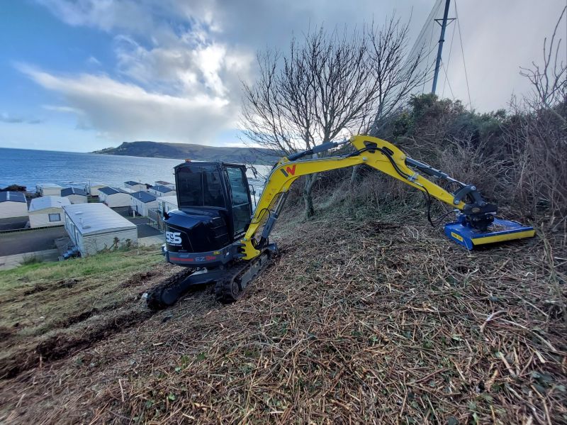 Slanetrac FH80 flail cutter on a mini digger clearing scrub on a bank