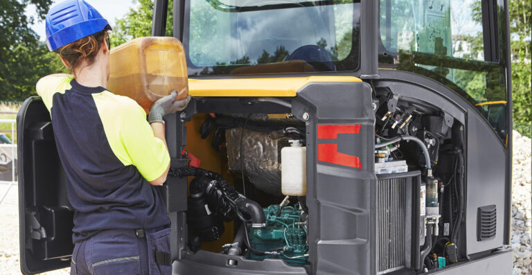 Engine compartment of a Volvo compact excavator opened for daily checks